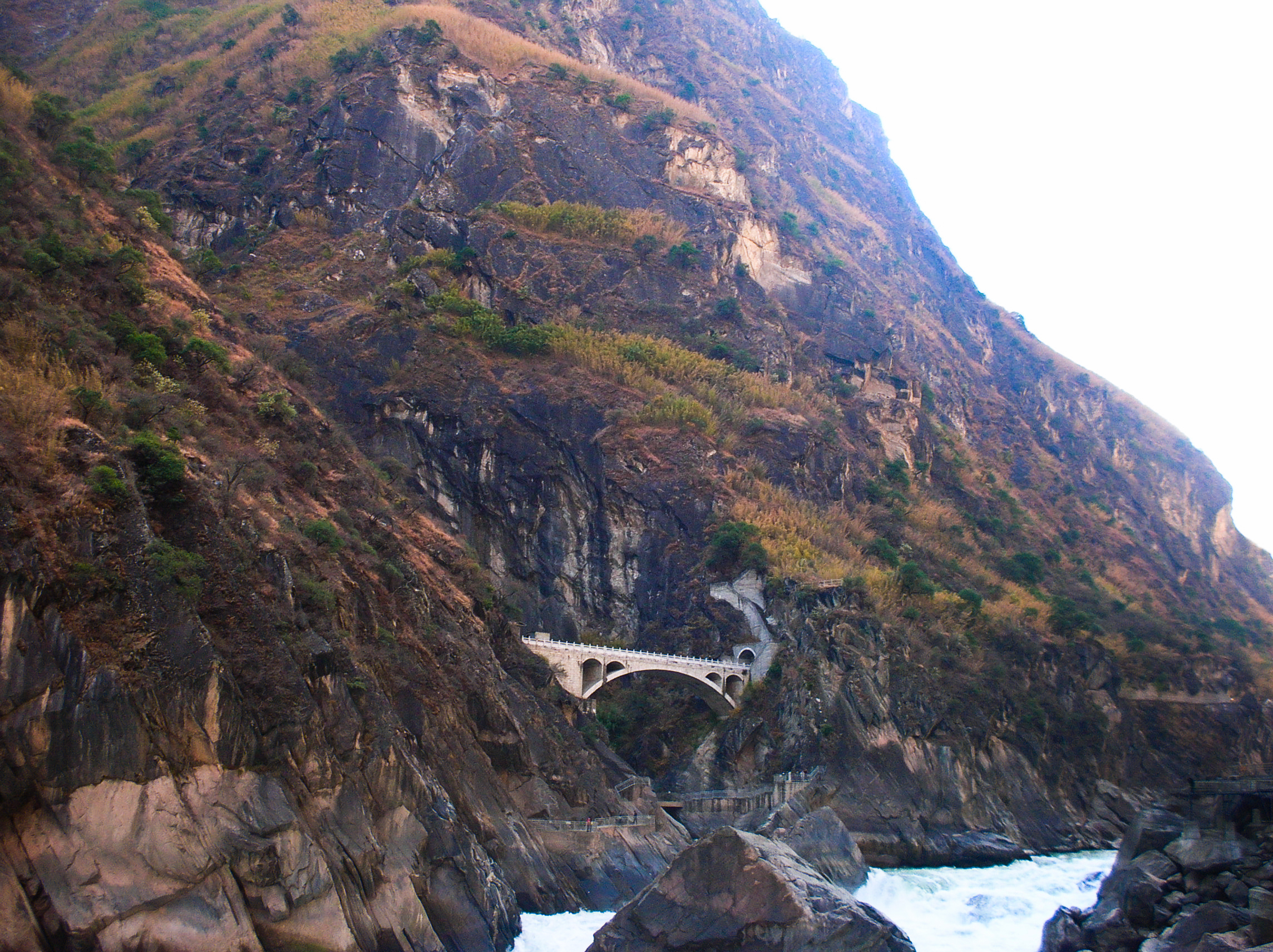 Bridge over a gorge with trees on either side.